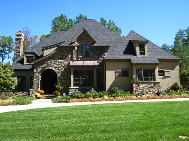 New vinyl siding and stone veneer installation on a residential home